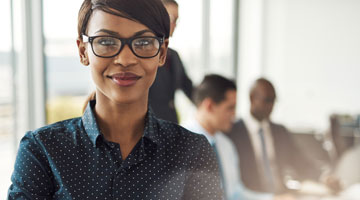 Confident woman standing in front of business meeting
