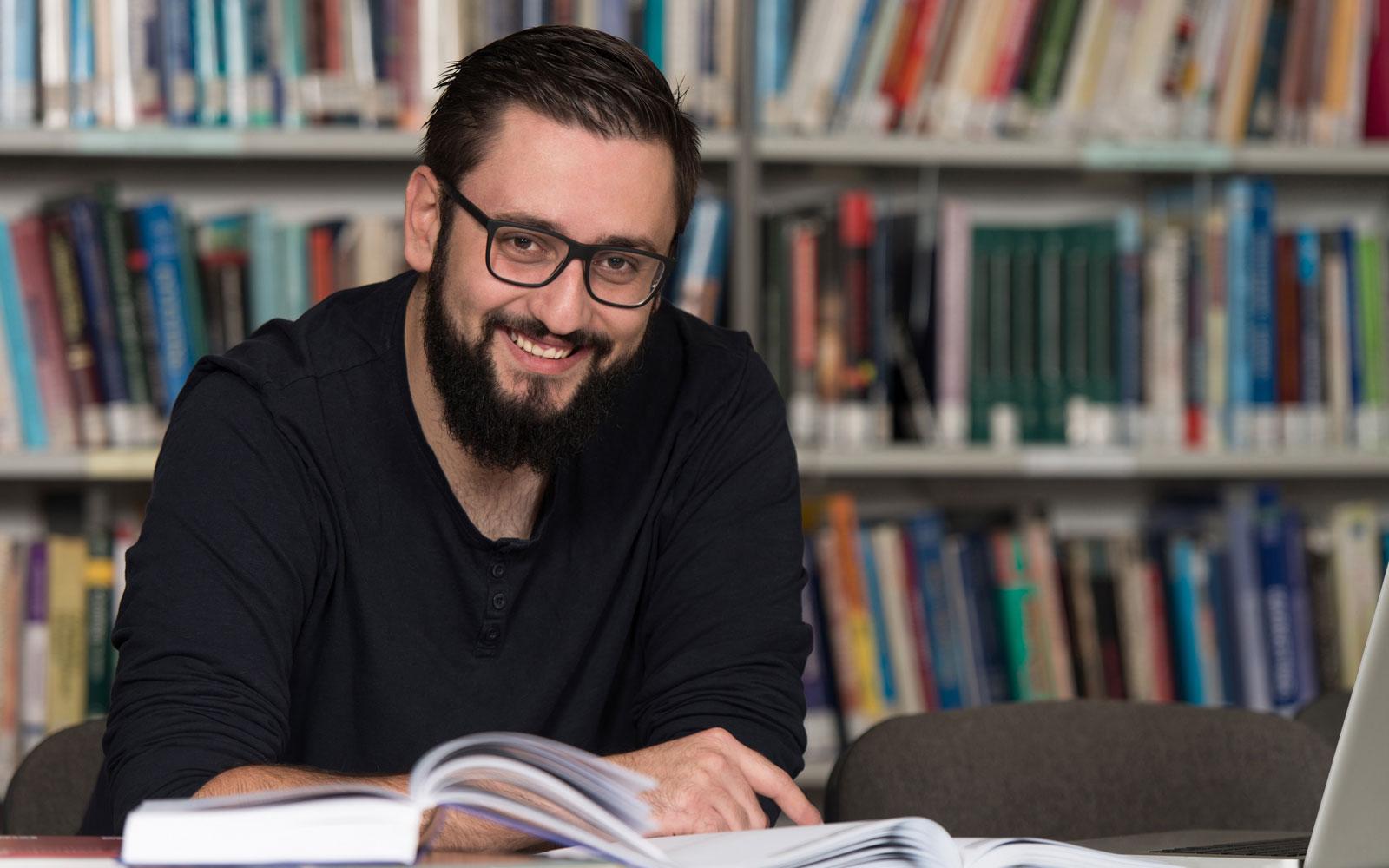 Online liberal arts student in library