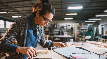 Woman in a workshop building construction model