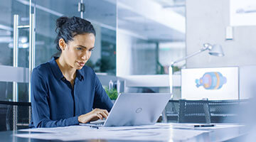Woman working on her laptop at desk
