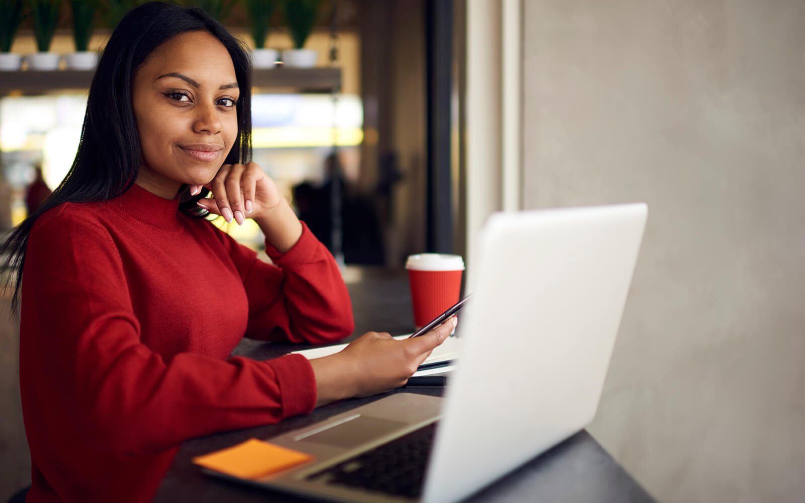 Women working at coffee shop on computer