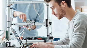 Technicians working on his laptop