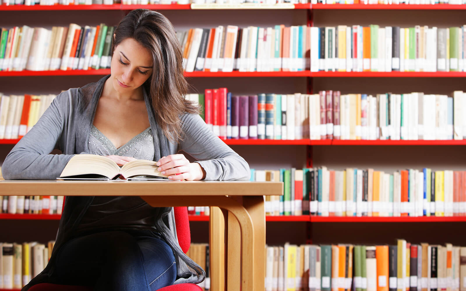 Woman reading a book at the library