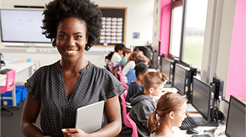 Teacher in computer class with kids