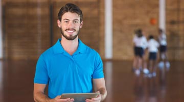 Coach standing in front of basketball team