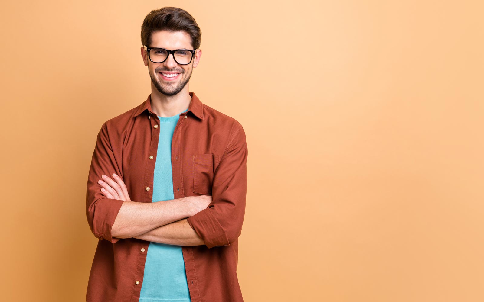 Man with his arms crossed smiling