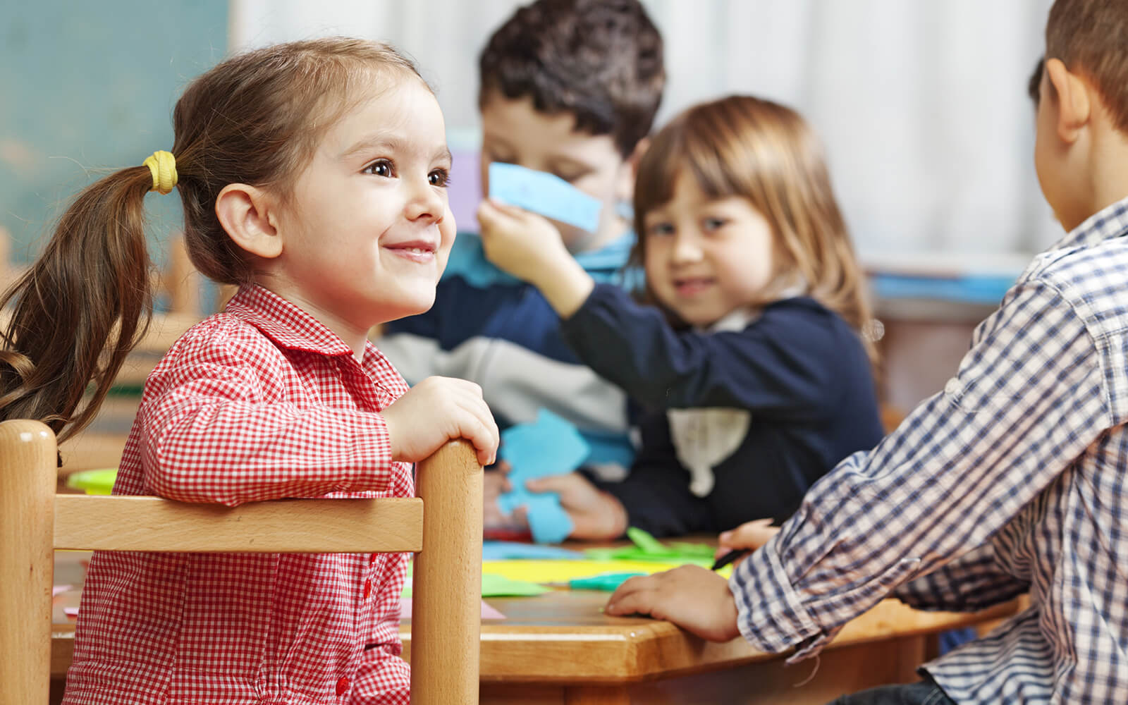 Kids playing at a table in school