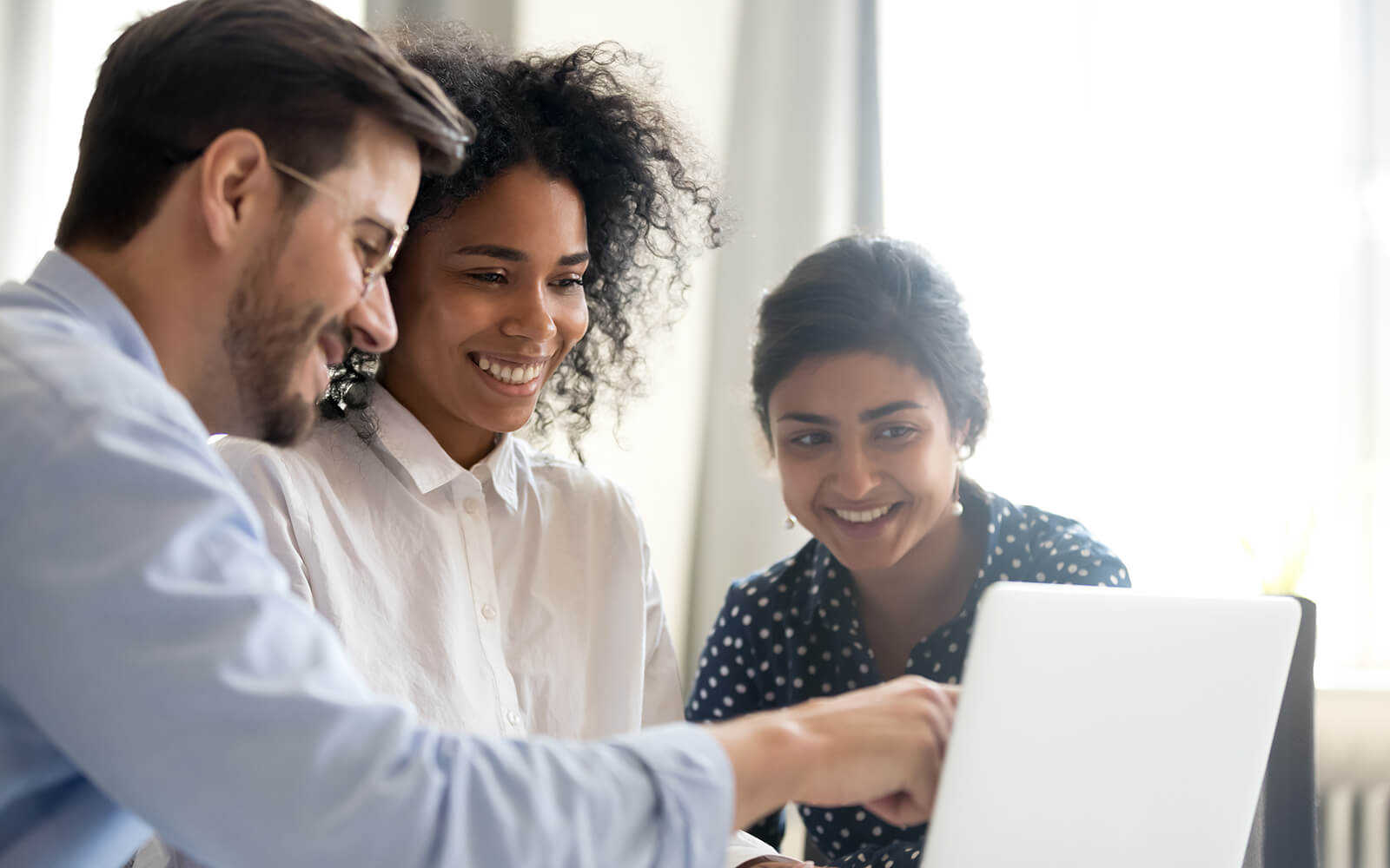 Three co-workers reviewing computer data