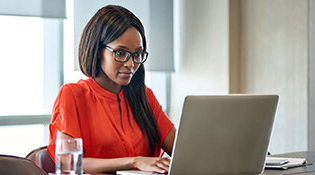 Woman working on her laptop at desk