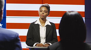 Woman standing in front of US Flag