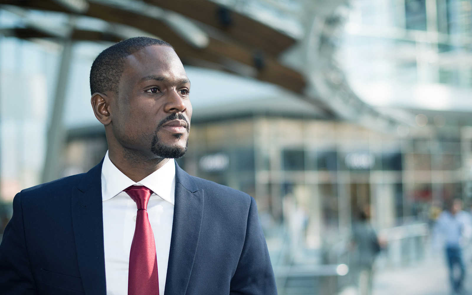 Man in suit in front of a building