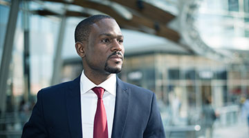 Man in suit in front of a building