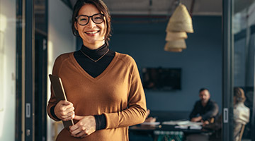 Woman holding a tablet smiling