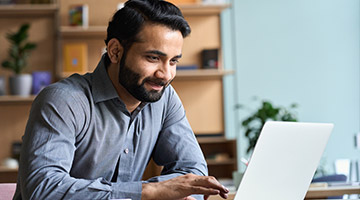 Man scrolling on his laptop