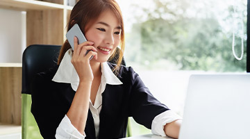 Business woman at her desk talking on the phone