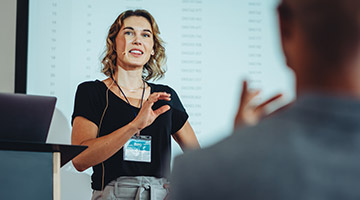 Woman giving a lecture to a group of people