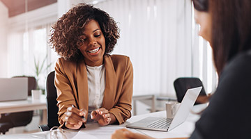 Financial analysts talking to another woman
