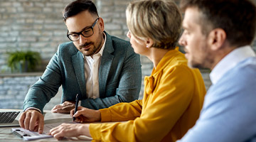Real Estate agent speaking with a couple