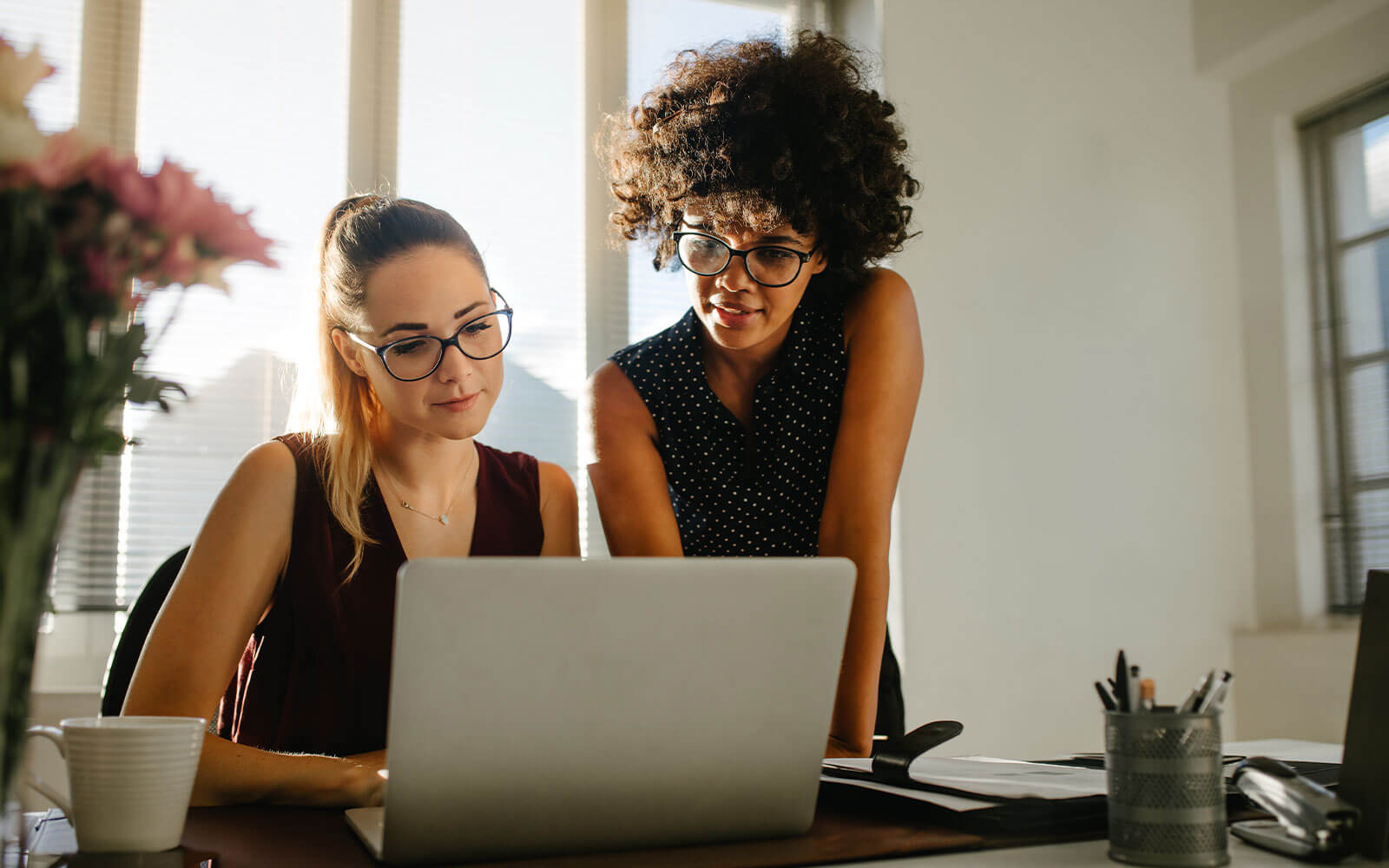 Two marketers looking at a laptopr