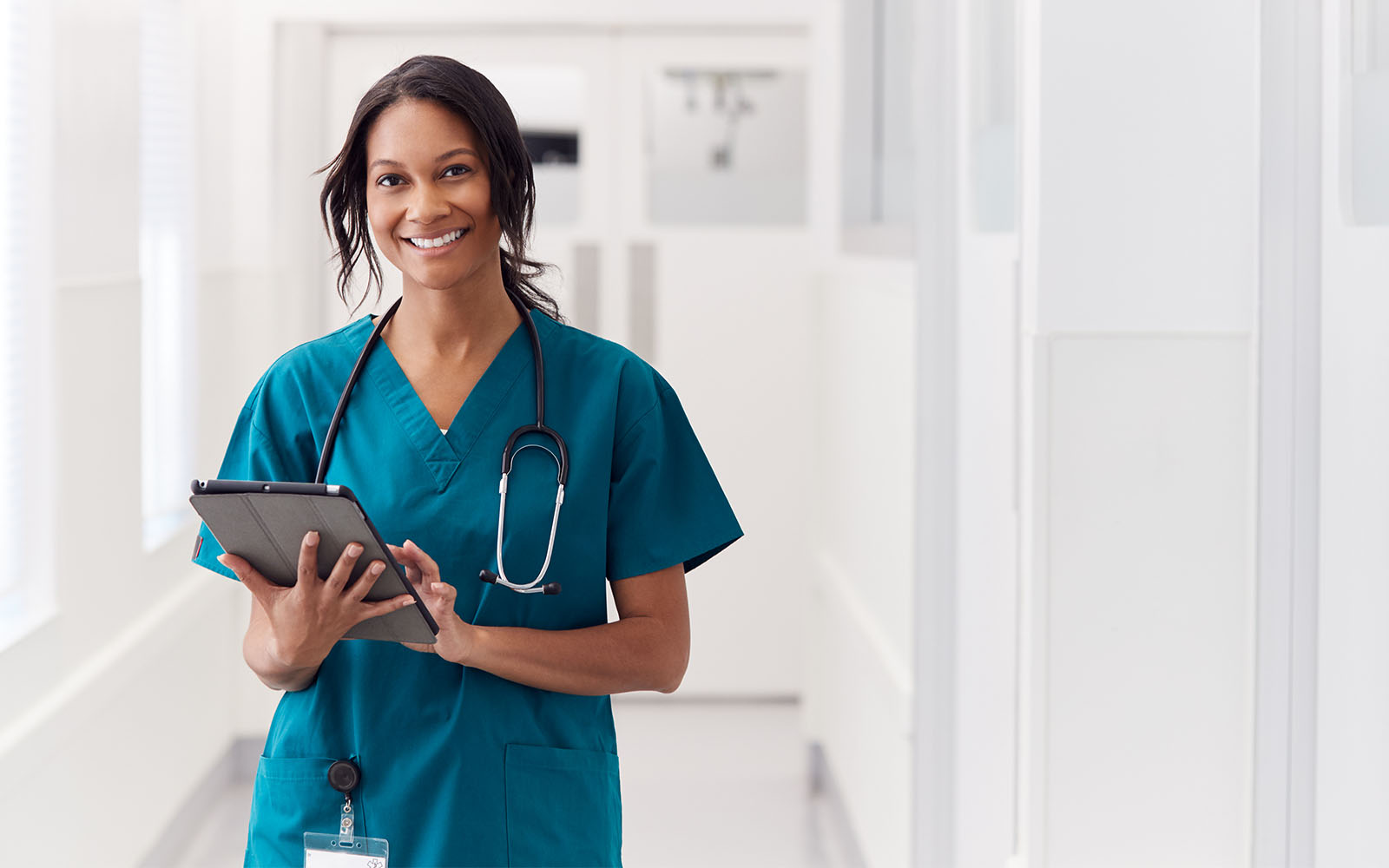 Nurse in front of a brick wall