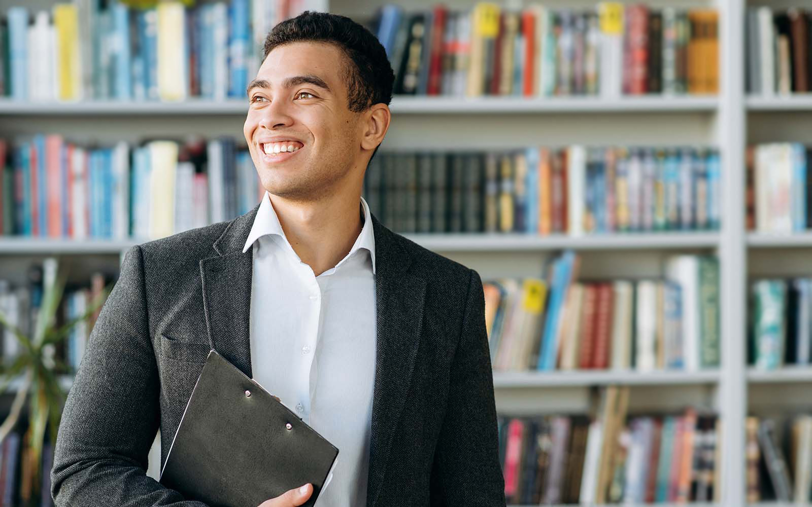 Man in business attire smiling.