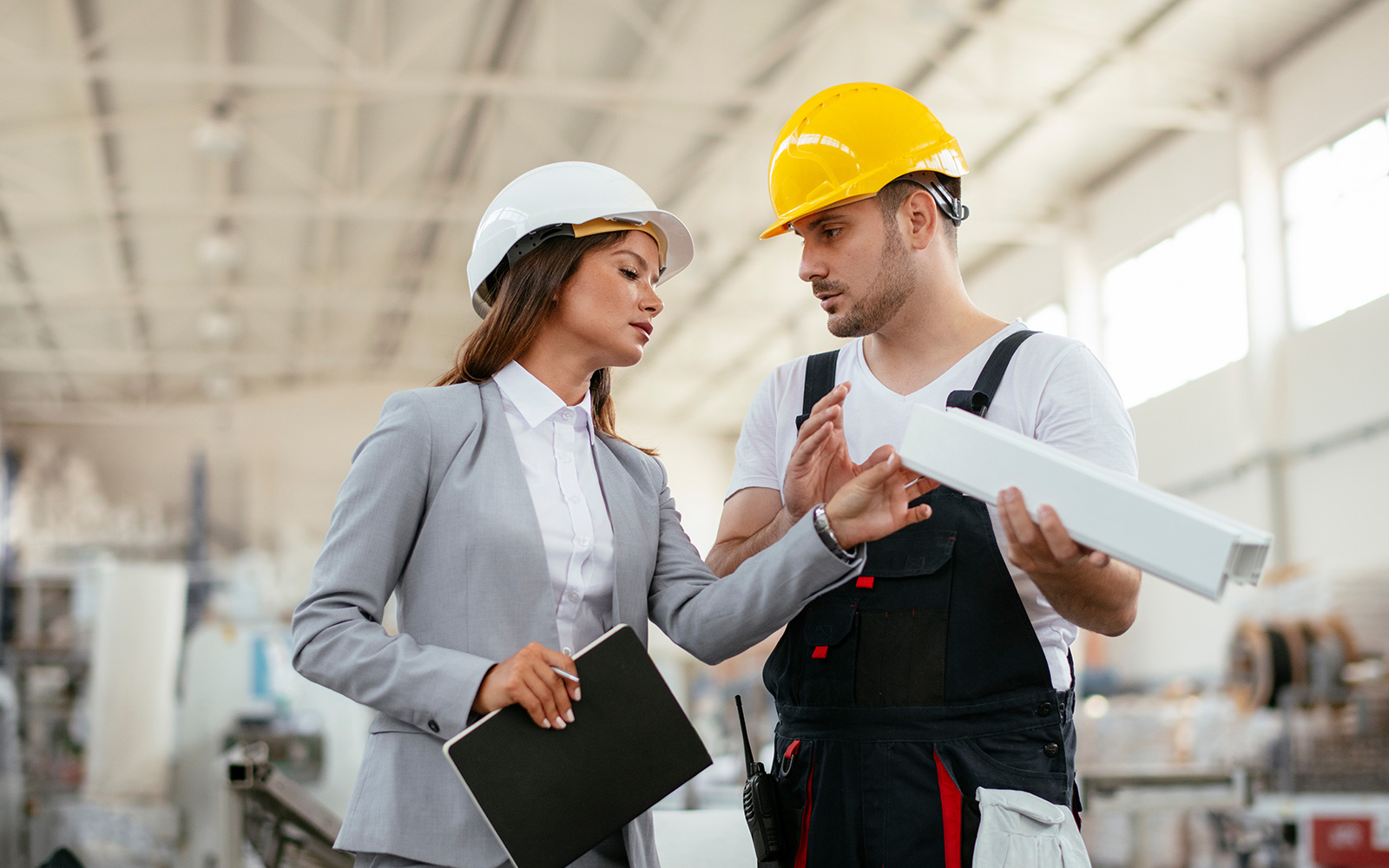 Man and woman inspecting a tool