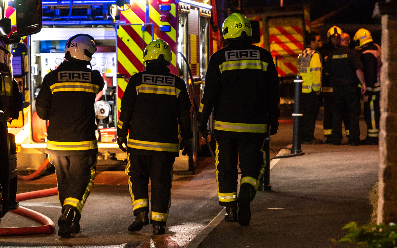 firefighters walking at scene of emergency