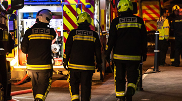 firefighters walking at scene of emergency