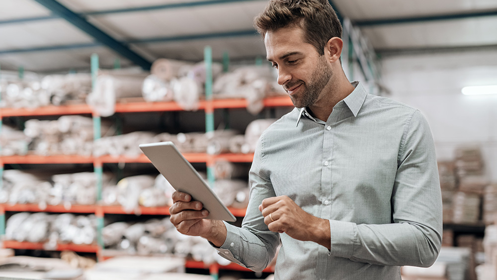 Man looking at inventory on tablet