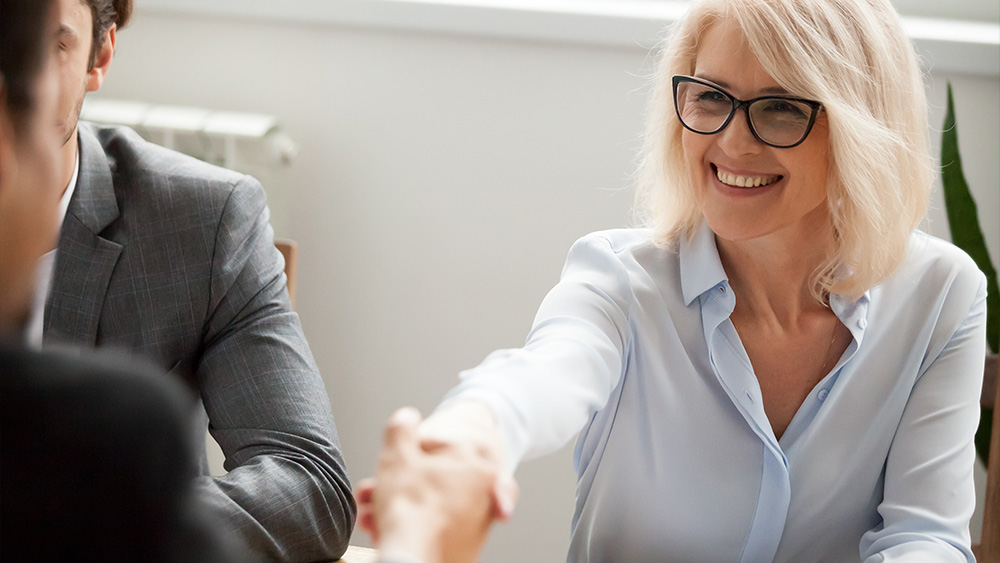 Group of three people in a meeting.