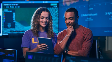 2 cyber security engineers working in a lab