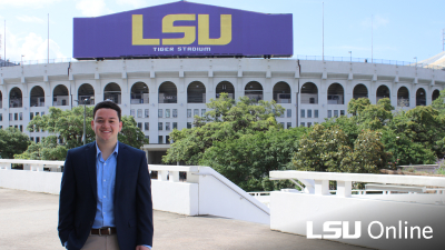Man standing in front of LSU Tiger Stadium
