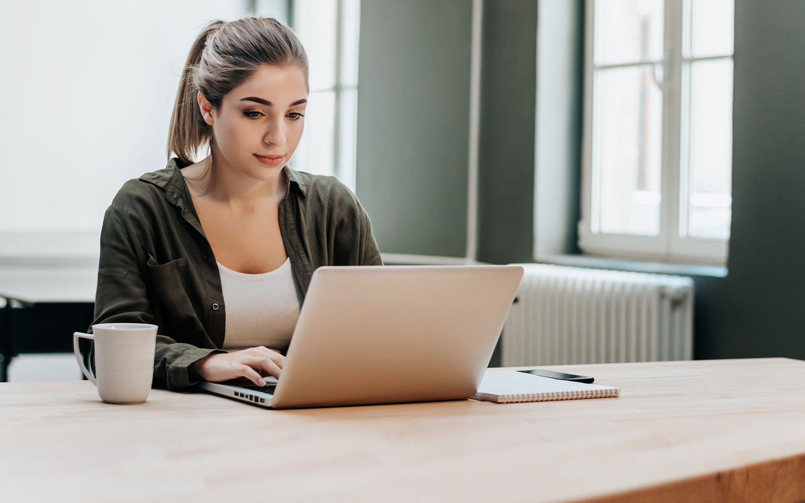 Woman working on computer at her desk