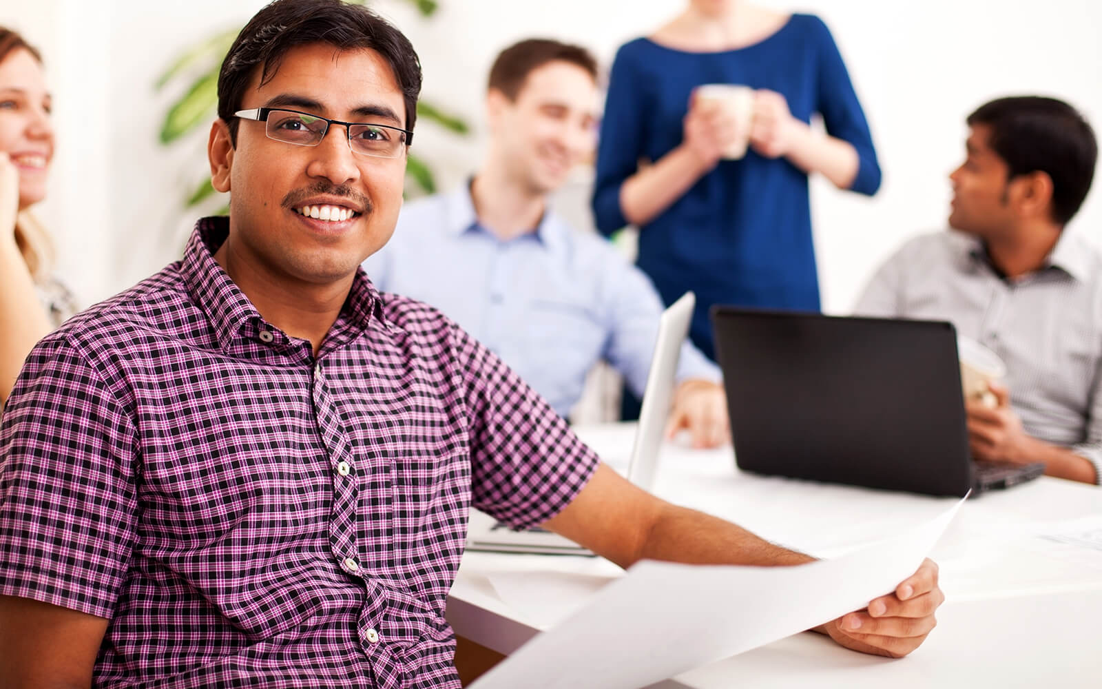 Man smiling in front of a group of people